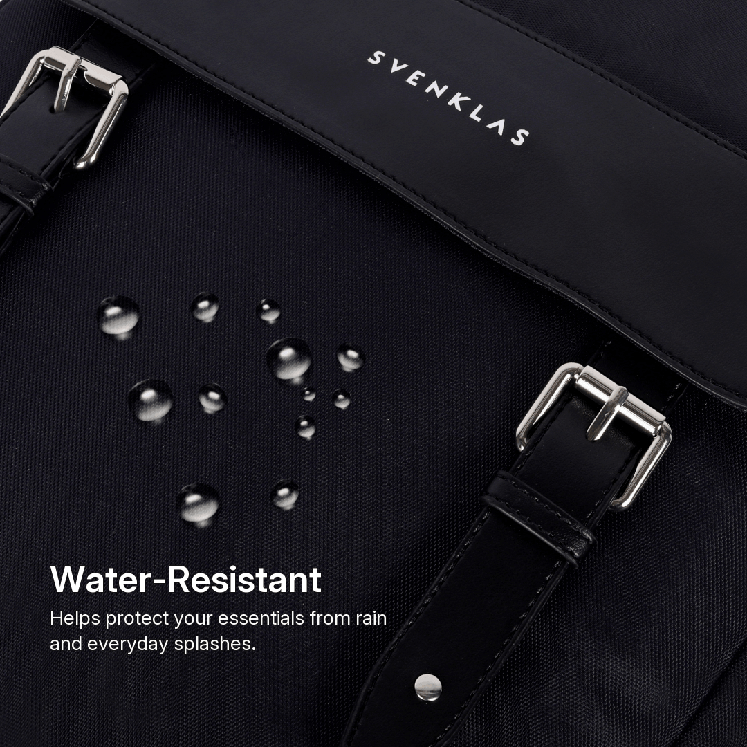 Close-up of a Svenklas Amber black waterproof backpack or bag with silver buckles, water droplets on the surface, and text reading 'Water-Resistant' and 'Helps protect your essentials from rain and everyday splashes.' The brand name 'SVENKLAS' is visible on the strap.